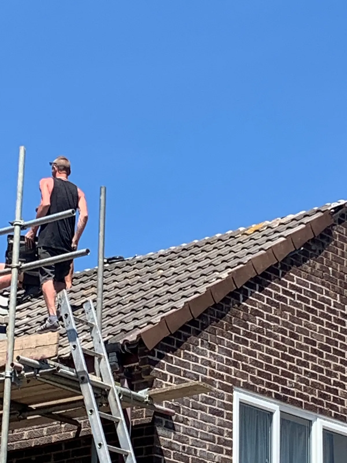 Roofer working on a newly tiled roof